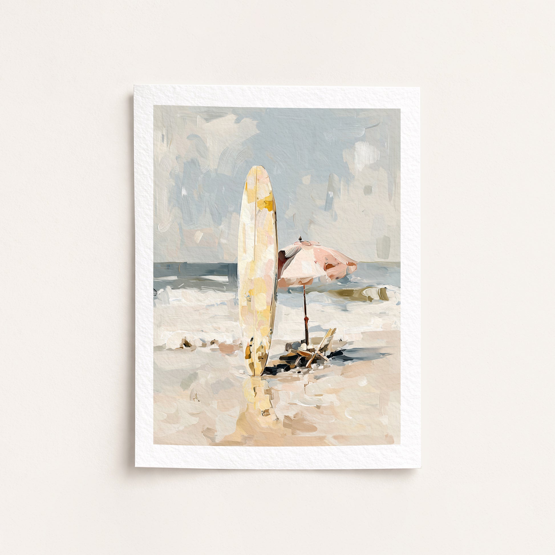 Framed artwork of a beach scene with a surfboard and umbrella on a white wall.