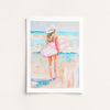 Framed artwork of a woman with a pink surfboard on a beach