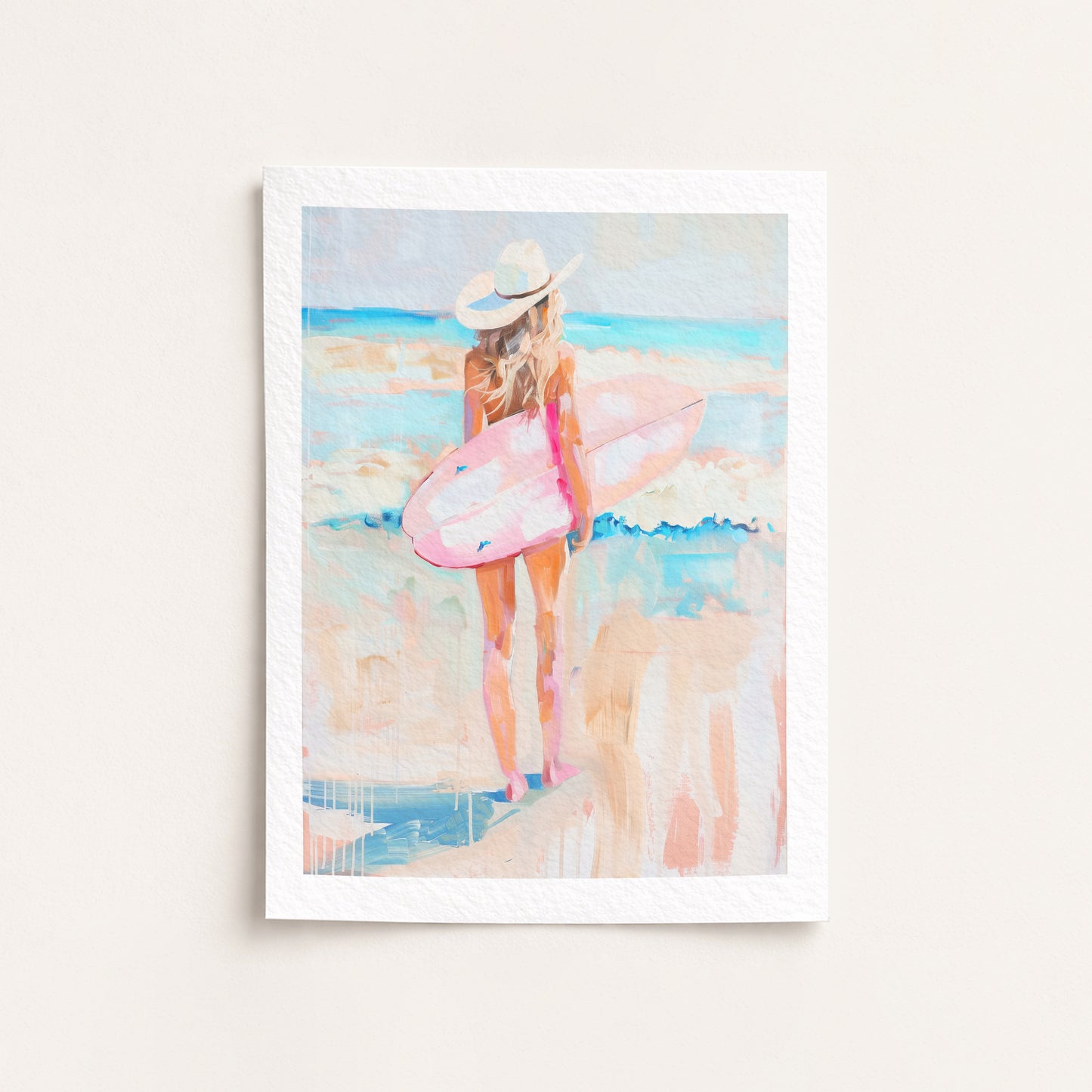 Framed artwork of a woman with a pink surfboard on a beach
