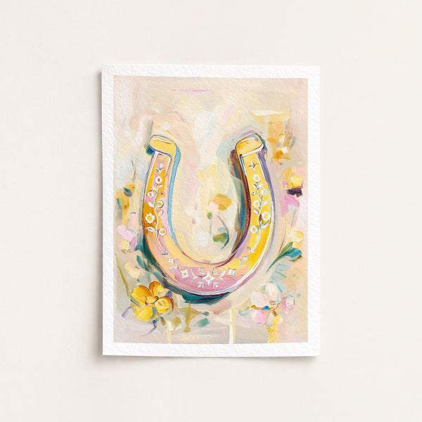 Framed artwork of a colorful horseshoe with flowers on a light background
