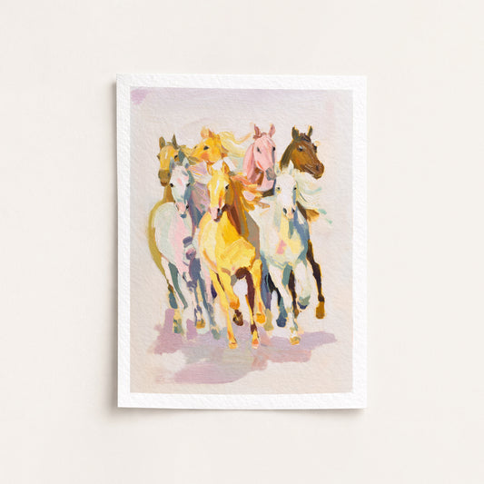 Framed artwork of colorful horses on a light background