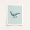Framed artwork of a whale on a light blue background