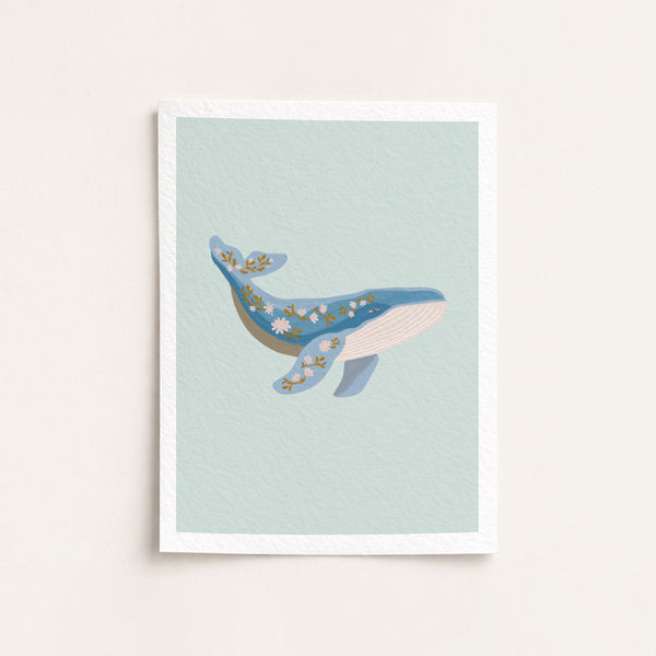 Framed artwork of a whale on a light blue background
