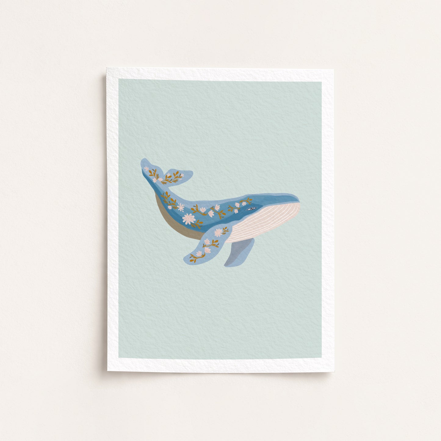 Framed artwork of a whale on a light blue background