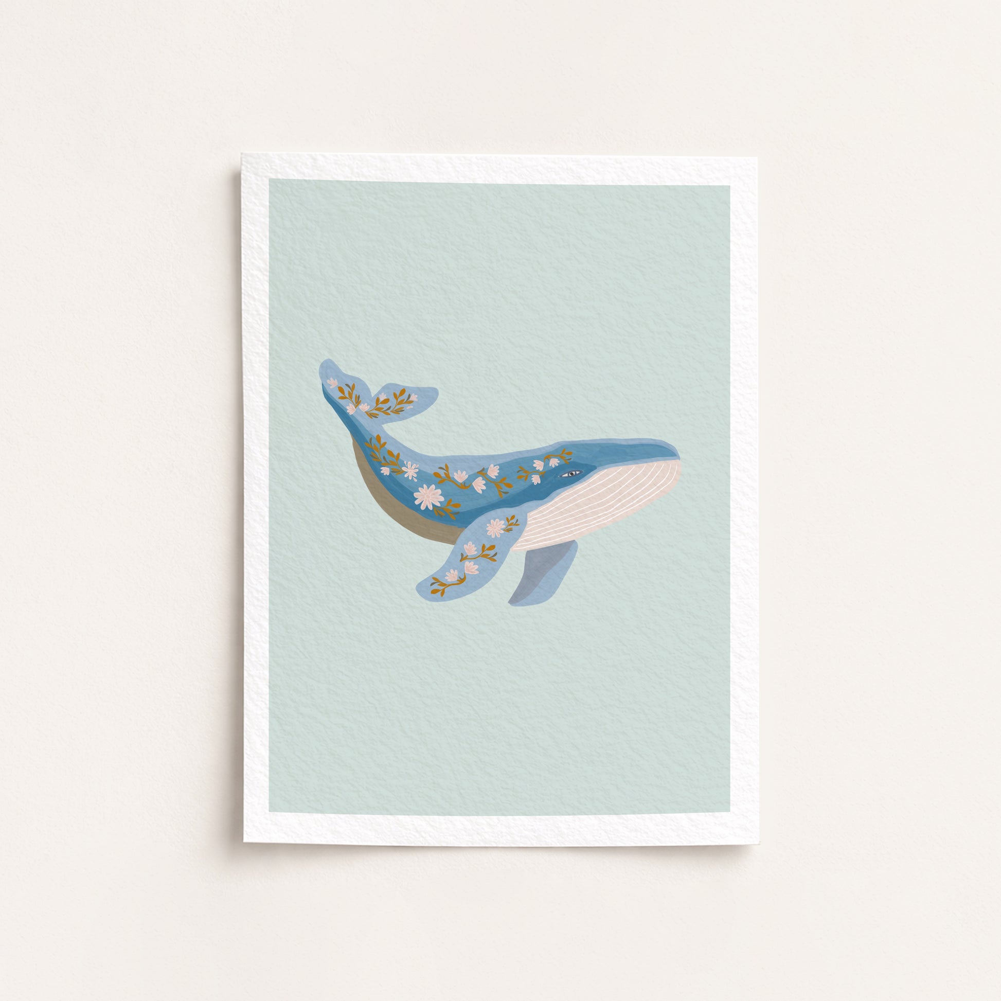Framed artwork of a whale on a light blue background