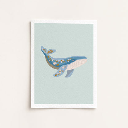 Framed artwork of a whale on a light blue background