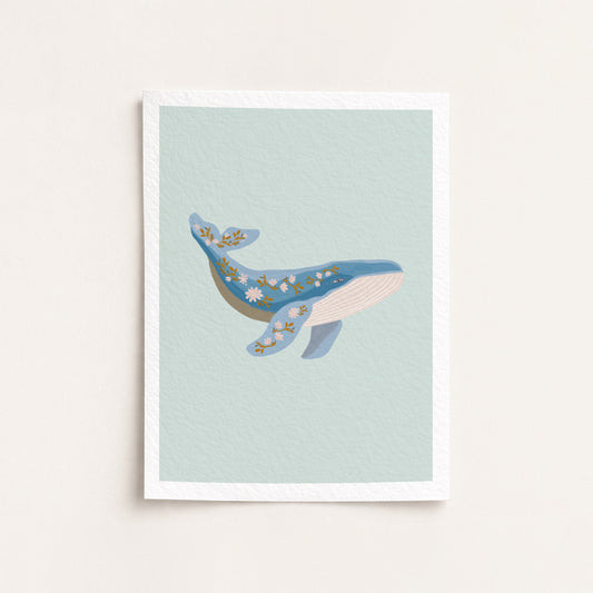Framed artwork of a whale on a light blue background