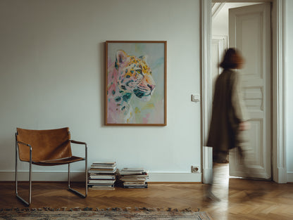 Living room with a brown leather chair, stack of books, and colorful tiger painting on the wall.