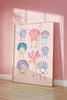 Framed artwork of colorful seashells with ribbons on a pink wall.