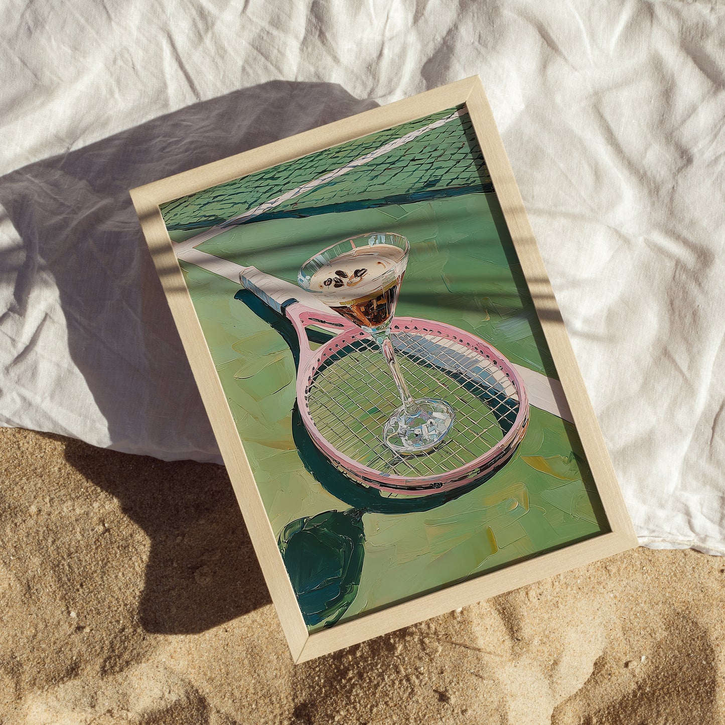Framed artwork of a pink tennis racket with a glass on a tennis court.