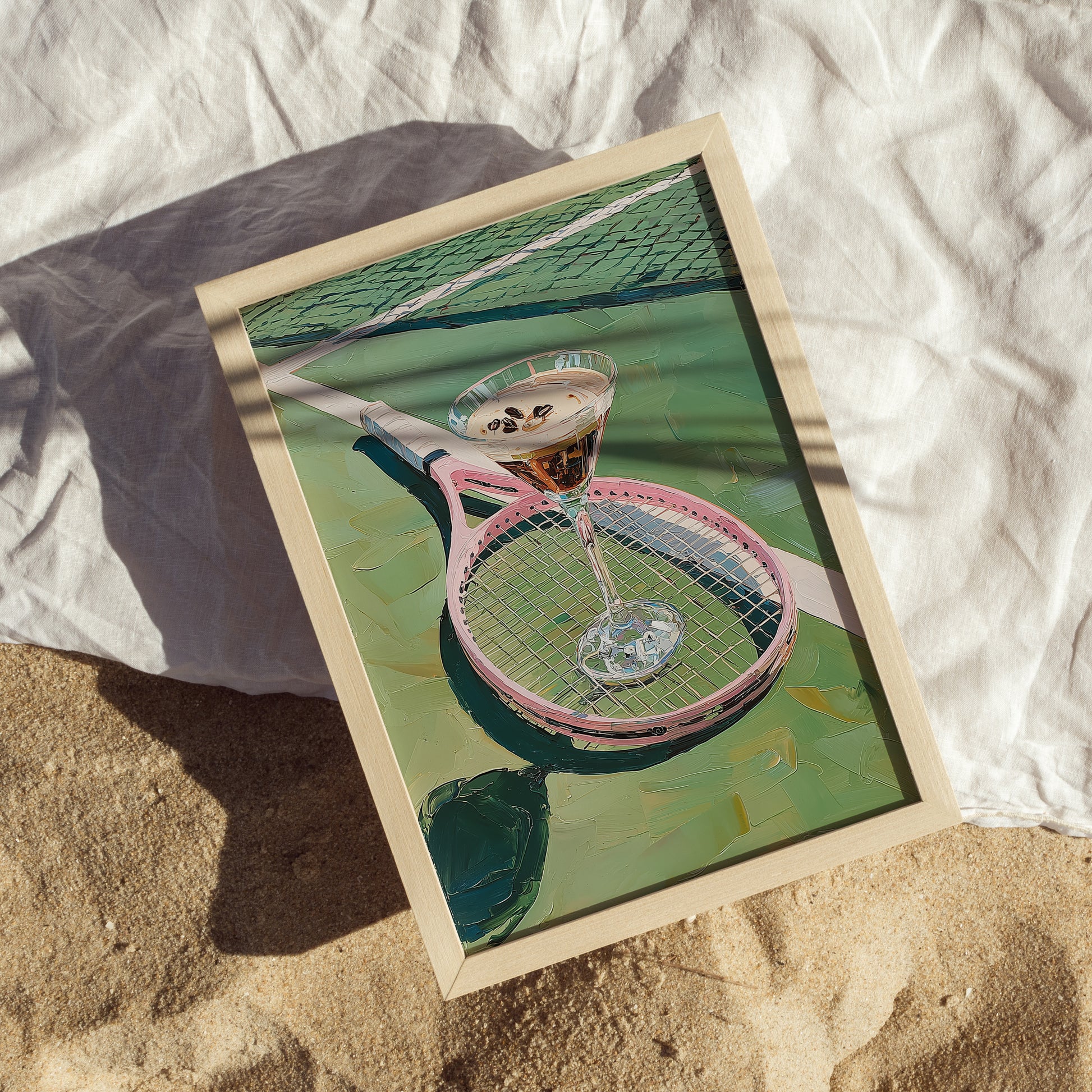 Framed artwork of a pink tennis racket with a glass on a tennis court.