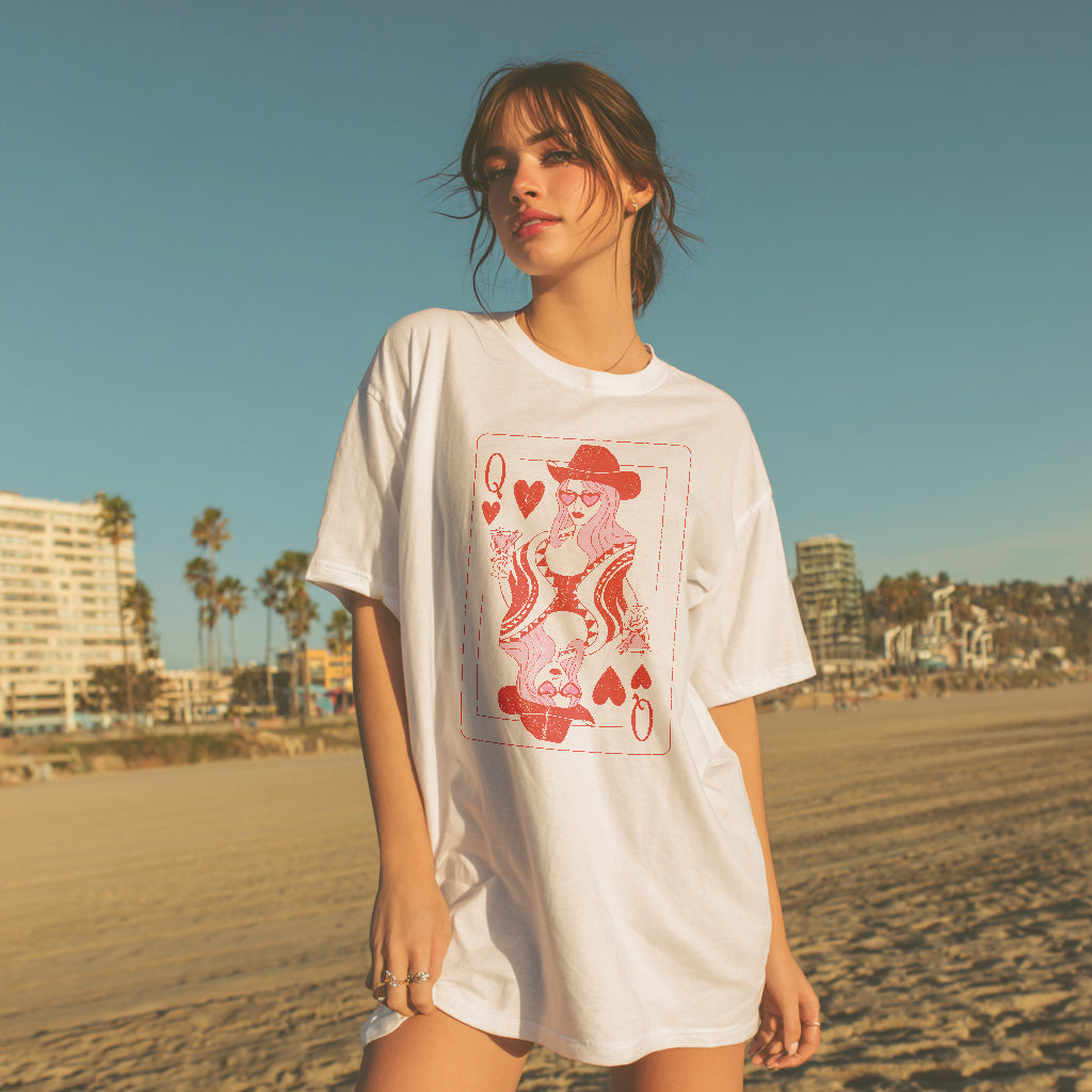 Woman wearing a white t-shirt with a graphic design on a beach