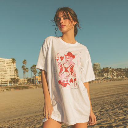 Woman wearing a white t-shirt with a graphic design on a beach