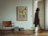 Brown leather chair and colorful horse painting in a room with a person walking by.
