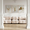 Beige sofa in a room with framed artwork on the wall