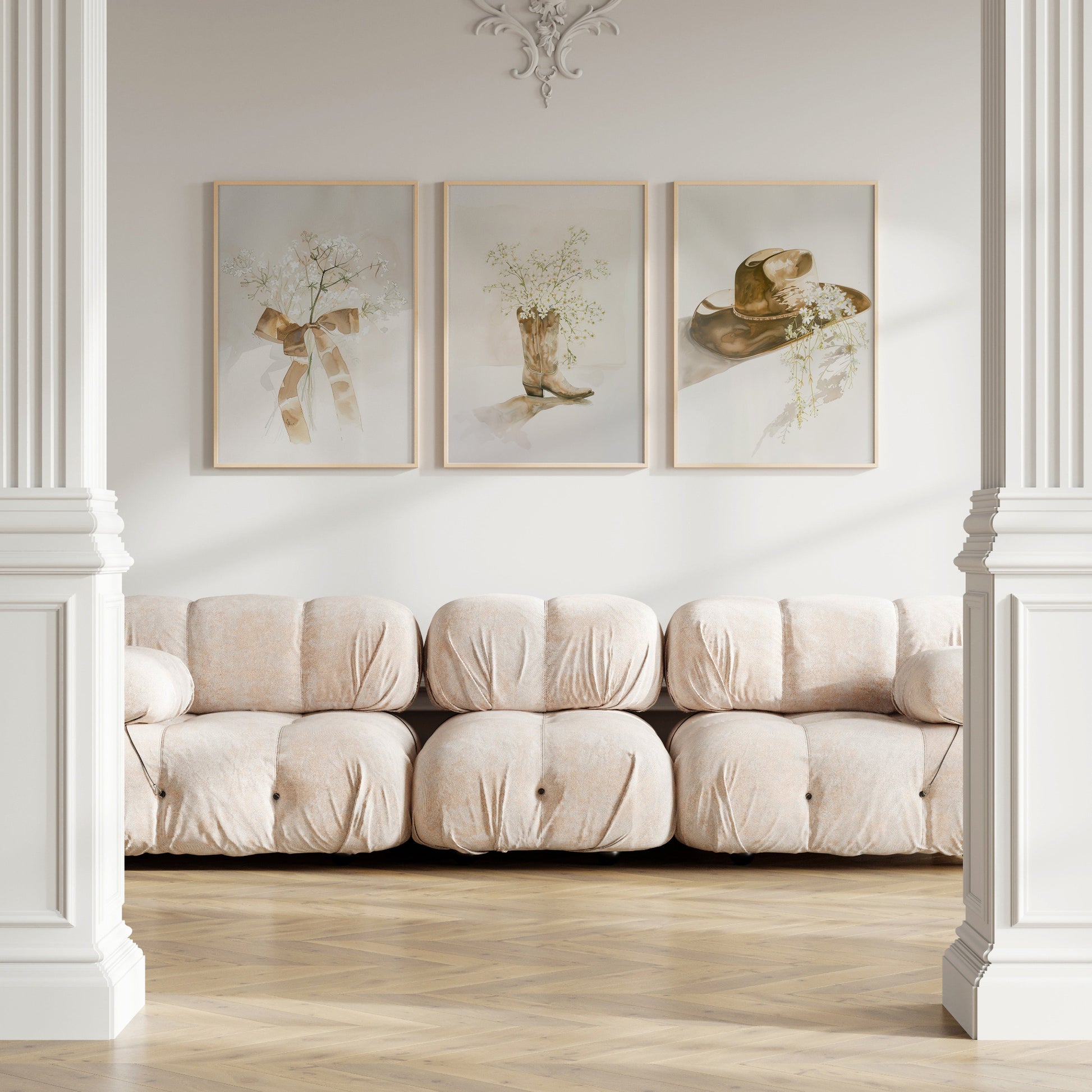Beige sofa in a room with framed artwork on the wall