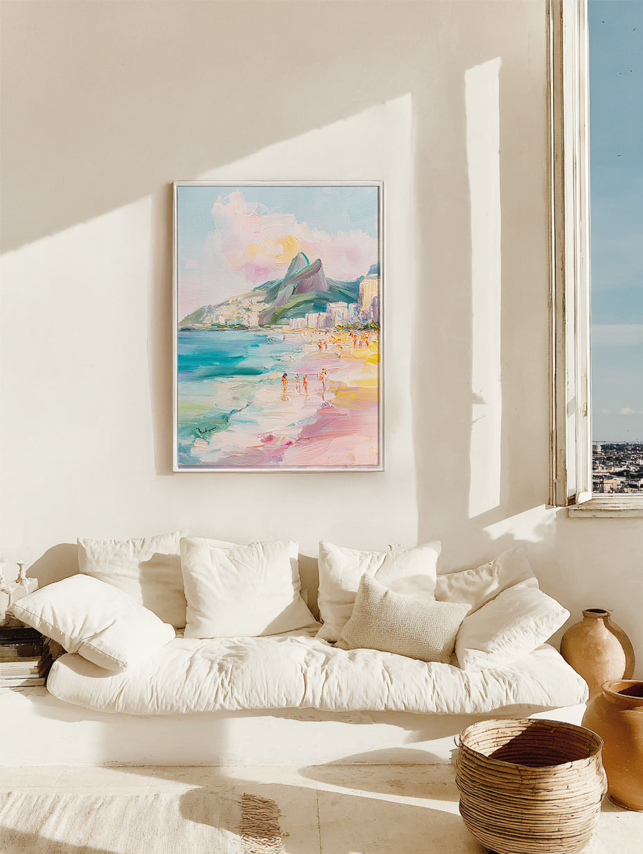Framed artwork of a coastal scene above a white sofa in a bright room with a window.