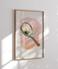 Framed artwork of a tennis racket with abstract design on a light background