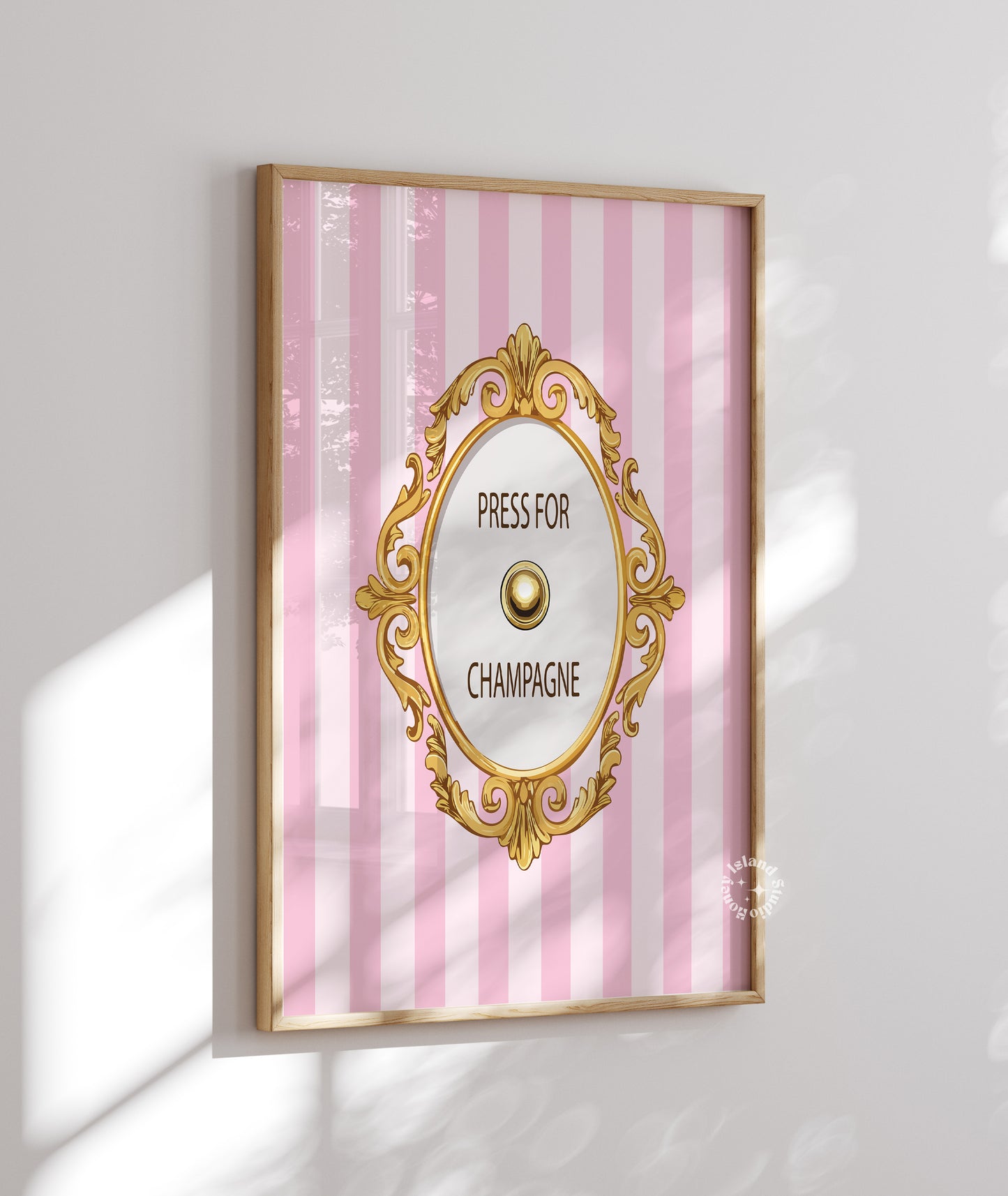 Decorative wall art with pink striped background and gold frame on a white wall.
