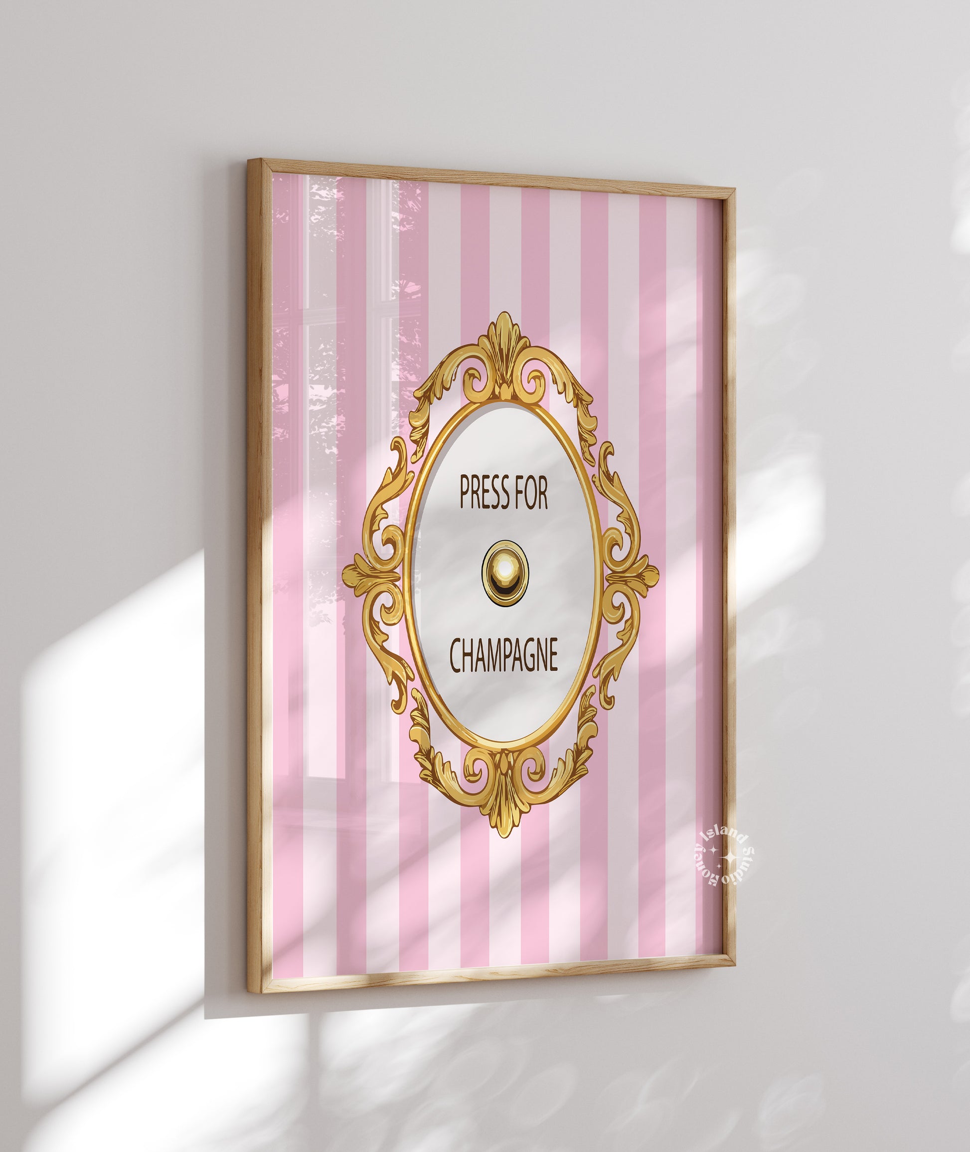 Decorative wall art with pink striped background and gold frame on a white wall.