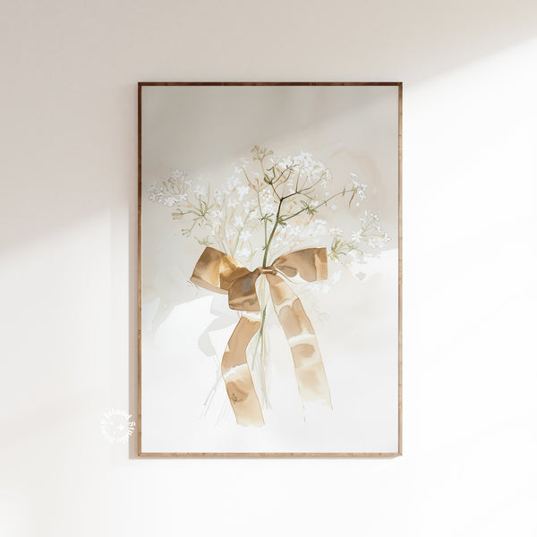 Framed artwork of white flowers with a gold bow on a light background